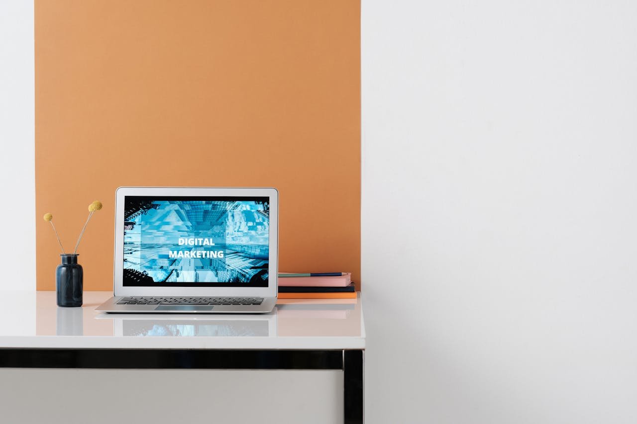 A clean, modern workspace featuring a laptop with digital marketing on screen, ideal for business use.