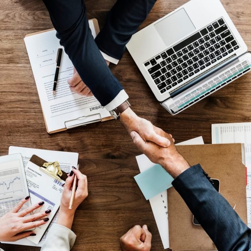business-people-shaking-hands-together business-people-shaking-hands-together